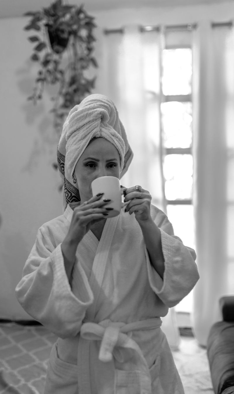 A woman relaxing at home with coffee in natural light